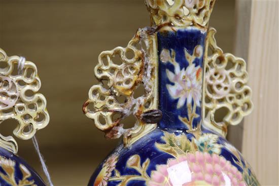 A pair of Zsolnay Pecs reticulated vases, floral-decorated on a blue ground and heightened in gilt height 20cm (a.f.)